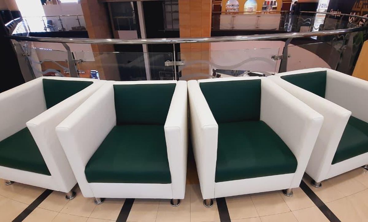 Amer Center armchairs with white surrounds and deep-green seat and back cushions
